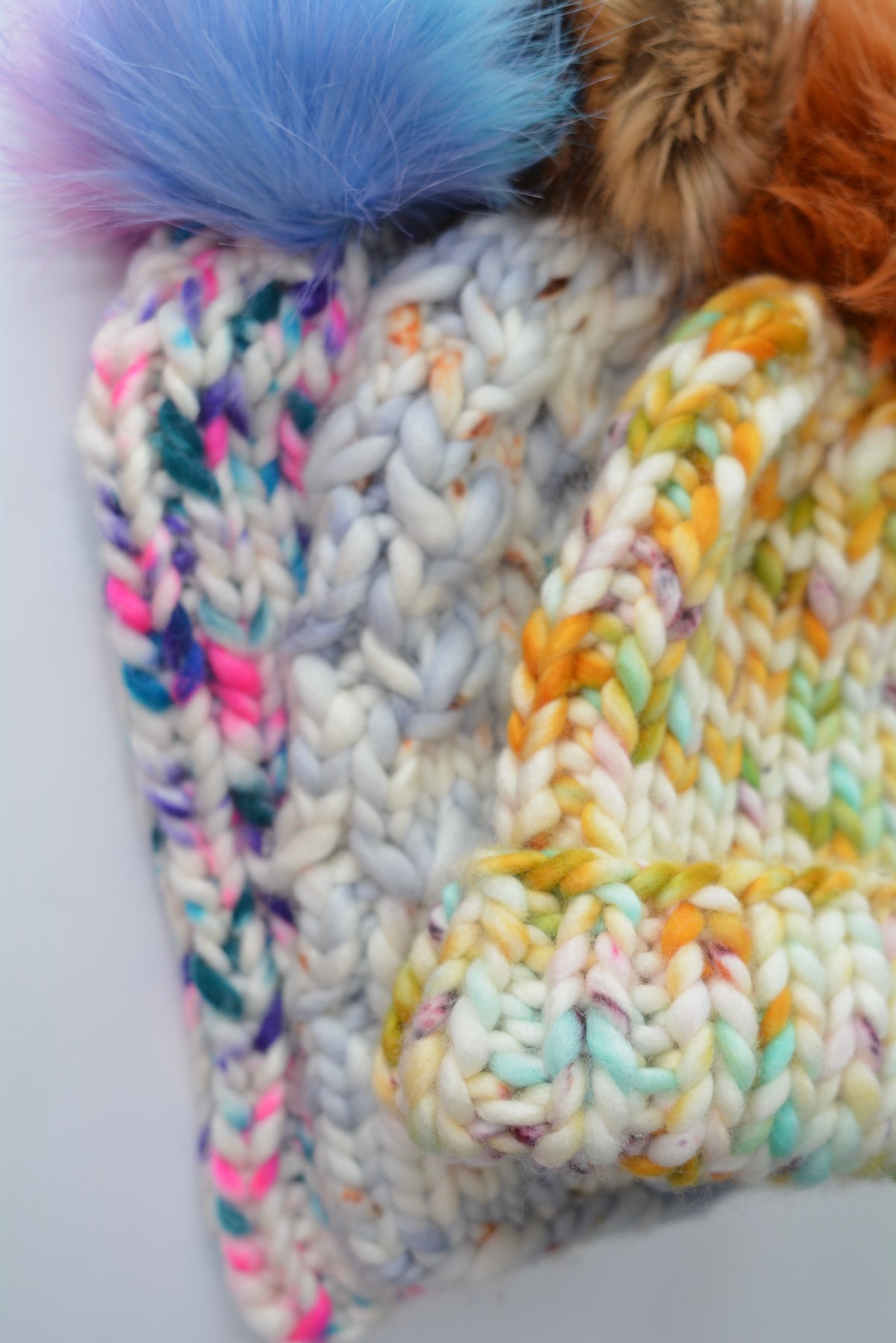 colourful all wool beanies with pompoms