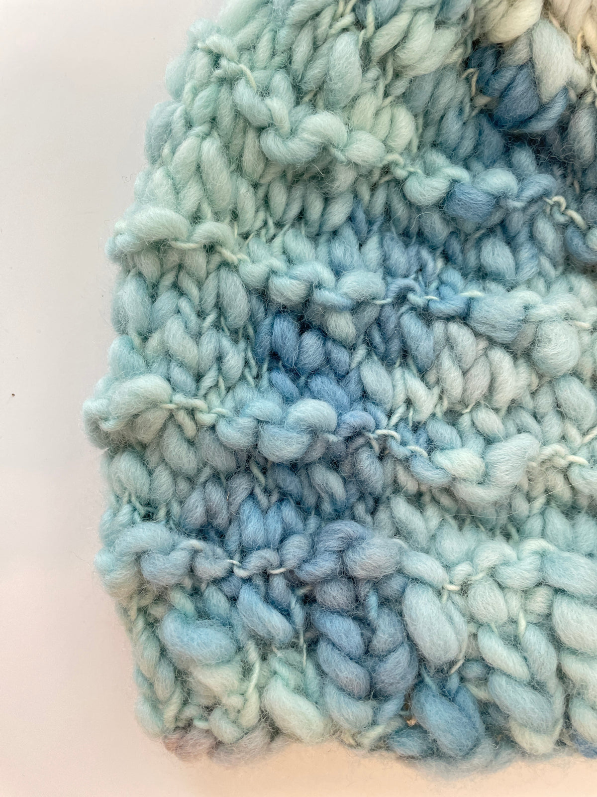 WAVE OVER WAVE IN SIRMILIK WITH LIGHT BLUE POM